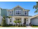Charming two-story home with a covered front porch and beautiful landscaping, creating great curb appeal at 7266 Kodiak Ln, Sarasota, FL 34240