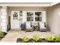 Inviting front porch with brick pavers, seating, and charming decorative accents create a welcoming entrance at 12162 Aurora Ct, Largo, FL 33774