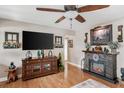Charming living room features a stone fireplace, a large television, and stylish furnishings, creating a cozy atmosphere at 12162 Aurora Ct, Largo, FL 33774