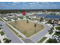 A high aerial view displays a community with a lake, green space, and houses on a sunny day at 13006 Tidal Flats Loop, Riverview, FL 33579