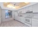 Bright all-white kitchen featuring a window, sleek appliances, and modern countertops at 1321 N Mcmullen Booth Rd # 1321, Clearwater, FL 33759