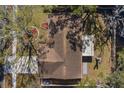 Aerial roof view of a home showcasing its layout and yard with mature trees at 1582 Sandalwood Dr, Dunedin, FL 34698
