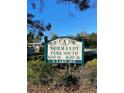 Normandy Park South community sign with well-maintained landscaping in a sunny neighborhood at 1616 S Lake Ave # 4, Clearwater, FL 33756