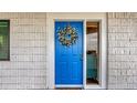 Bright blue front door adorned with a decorative wreath providing a warm and inviting entrance at 2 Adalia Ave # 803, Tampa, FL 33606