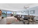 Stylish living room with a ceiling fan, coastal decor, and sliding doors to a waterfront balcony at 2 Adalia Ave # 803, Tampa, FL 33606