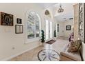 Inviting foyer with tiled flooring, a decorative compass design, arched entryway, and a chandelier at 22259 Skyview Cir, Brooksville, FL 34602