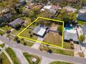 Aerial view showcasing the property's layout and surrounding neighborhood with mature trees and nearby amenities at 27 Park Ave, Tarpon Springs, FL 34689