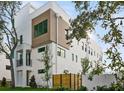 Stylish townhouse with a modern design, showcasing clean lines, a small balcony, and beautiful landscaping at 305 15Th N St, St Petersburg, FL 33705