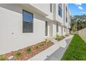 Close-up exterior view of the townhouses, showcasing the architectural details, landscaping, and modern design at 305 15Th N St, St Petersburg, FL 33705