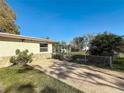 Exterior view of home featuring a well-maintained lawn, driveway, and fenced yard at 3501 Beechwood N Ter, Pinellas Park, FL 33781