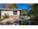 Well-maintained home featuring stone accents, landscaping, and a screened-in porch at 3501 Beechwood N Ter, Pinellas Park, FL 33781