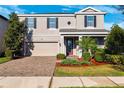 Charming two-story home featuring a well-manicured lawn and brick paved driveway at 4195 Welling Ter, Land O Lakes, FL 34638
