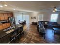 Open concept living room and kitchen with modern stainless steel appliances at 4210 Pacente Loop, Zephyrhills, FL 33543