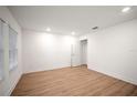 Well-lit bedroom features wood-look flooring, a closet, and a neutral color palette at 4511 S Manhattan Ave # 18, Tampa, FL 33611