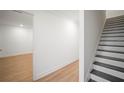 Bright entryway showcasing wood floors, white trim, and a staircase with dark treads at 4511 S Manhattan Ave # 18, Tampa, FL 33611