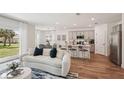 Inviting living room with stylish furniture flowing into an open kitchen with a breakfast bar at 4754 Easter Ter, North Port, FL 34286