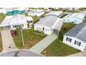 An aerial view shows the home with landscaping, well-maintained lawns, and a patterned driveway at 4946 Blanco Dr, Zephyrhills, FL 33541