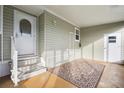 A covered carport featuring a patterned floor and access to both the front door and another exterior door at 4946 Blanco Dr, Zephyrhills, FL 33541