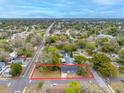 Sprawling aerial view of charming home nestled among mature trees in a quiet neighborhood at 6232 Jackson St, New Port Richey, FL 34653
