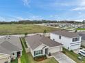 Suburban home with fenced yard backing up to large open field at 7608 Broad Pointe Dr, Zephyrhills, FL 33540
