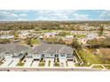 Aerial view of townhomes in a community setting with serene pond and verdant landscaping at 7782 93Rd N St, Seminole, FL 33777