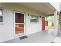 The front door of the home is red and has a glass screen door, along with other front doors at 800 71St N Ave # 8, St Petersburg, FL 33702