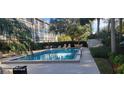 Resort style pool with outdoor seating and lush landscaping at 90 S Highland Ave # 224, Tarpon Springs, FL 34689