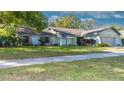 Charming single Gathering home with lovely lawn, attached garage, and beautiful landscaping at 903 Setter Ct, Seffner, FL 33584