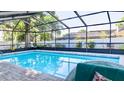Enclosed swimming pool with brickwork and exterior seating, perfect for entertaining guests at 903 Setter Ct, Seffner, FL 33584