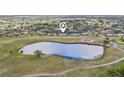 Scenic aerial view of the neighborhood homes with a tranquil lake at 1015 Harefield Cir, Sun City Center, FL 33573