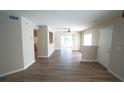 Open concept living room with sliding glass doors offering ample natural light and hardwood floors at 10811 Brickside Ct, Riverview, FL 33579