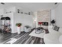 Bright living room features a stone accent wall with fireplace, modern furniture, and stylish decor at 14247 Spanish Wells Dr, Hudson, FL 34667