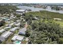 Aerial view of the single-Gathering home surrounded by lush greenery and nearby waterway at 14330 Channel Dr, Largo, FL 33774