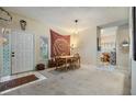 Open dining room with a wood table, mandala tapestry, a decorative peace sign and carpeted floors at 1822 Lake Cypress Dr # 1822, Safety Harbor, FL 34695