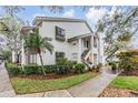 Exterior view of this multi-story condo showcasing the well-maintained landscaping and architectural design at 1822 Lake Cypress Dr # 1822, Safety Harbor, FL 34695