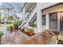 Inviting front entrance with brick walkway, flowers, and stairs leading to the second level unit at 1822 Lake Cypress Dr # 1822, Safety Harbor, FL 34695