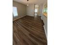 Spacious living room featuring lovely wood floors and a bright window with neutral paint at 1822 Lake Cypress Dr # 1822, Safety Harbor, FL 34695
