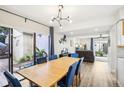 Open dining area with a wooden table, blue chairs, and view into a sunny outdoor patio at 1881 N Hercules Ave # 1205, Clearwater, FL 33765