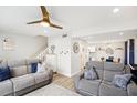 Inviting living room with two comfortable gray couches and access to the kitchen and dining area at 1881 N Hercules Ave # 1205, Clearwater, FL 33765