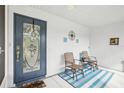 Inviting front porch with decorative door, comfortable seating, and a bright, welcoming atmosphere at 2022 Heathfield Cir, Sun City Center, FL 33573