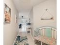 Bright hallway featuring tile floors and beach-themed decor leading into the living spaces at 2022 Heathfield Cir, Sun City Center, FL 33573