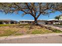 View of the front exterior of a single-story home with a front lawn at 2240 Harbor View Dr, Dunedin, FL 34698