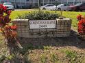 Community sign with address and landscaping in a well-maintained, grassy area at 2449 Columbia Dr # 29, Clearwater, FL 33763
