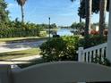 Enjoy serene water views from the porch, with lush landscaping and a glimpse of a nearby lake or canal at 310 Manns Harbor Dr, Apollo Beach, FL 33572