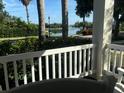 Picturesque water view from the porch, showcasing a tranquil lake or canal surrounded by lush greenery and palm trees at 310 Manns Harbor Dr, Apollo Beach, FL 33572