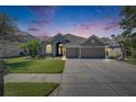 Beautiful home with an inviting exterior, showcasing a well-kept lawn, a long driveway, and a cozy ambiance at 3537 Valencia Cove Court, Land O Lakes, FL 34639