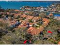 Wide aerial view of waterfront community homes featuring tile roofs, pools, docks and lush landscaping at 4605 Skimmer S Way, St Petersburg, FL 33711