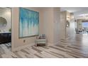 Hallway featuring modern flooring, elegant wall decor, and access to bathroom and living areas at 4951 Bacopa S Ln # 801, St Petersburg, FL 33715