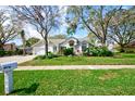 Charming one-story home with lush landscaping and a well-maintained lawn at 503 Old Grove Dr, Lutz, FL 33548