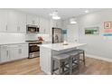 Bright kitchen featuring an island with seating and modern stainless steel appliances at 5351 Bridge St # 41, Tampa, FL 33611